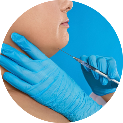 A close-up of a person receiving chin fillers with a syringe, showcasing the procedure in a clinical setting.