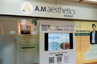The exterior of A.M. Aesthetics clinic featuring signage and informational displays.