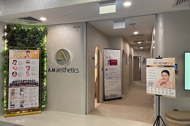 The entrance of A.M Aesthetics clinic showcasing signage and a welcoming environment.