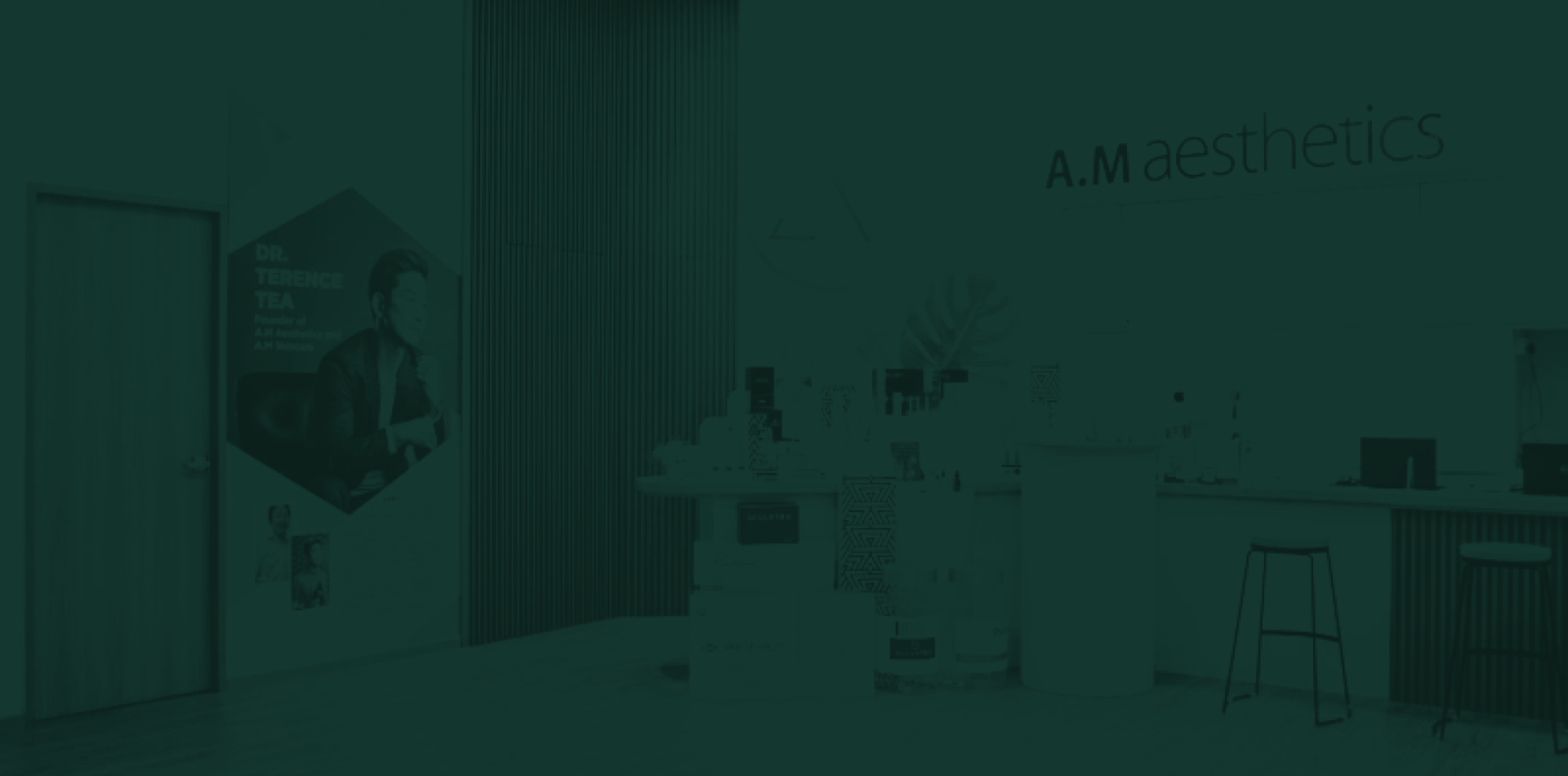 An interior view of the AM Aesthetic SG clinic featuring products displayed on a counter and a promotional image on the wall.