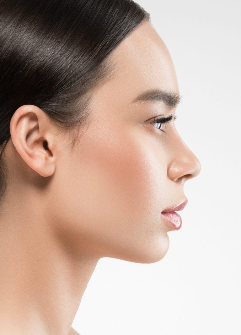 A profile view of a woman with elegant features against a light background.