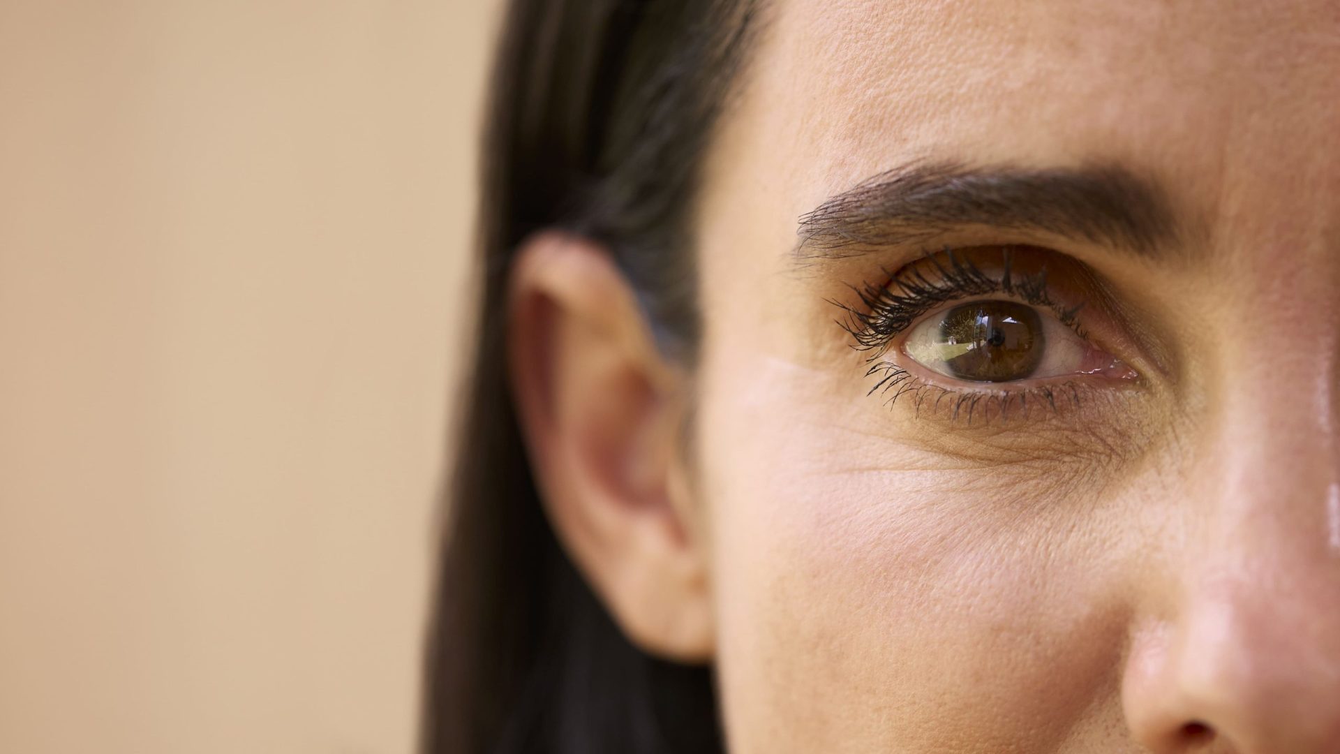 A close-up portrait capturing the eye and skin detail of a mature woman.